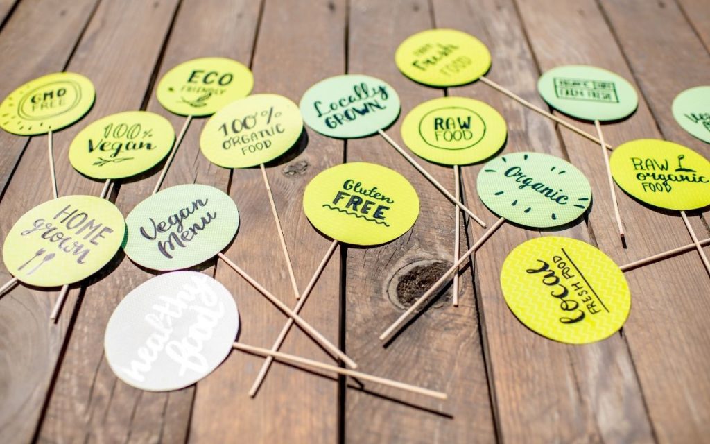toothpicks with common slogans on food labels sit on a table 