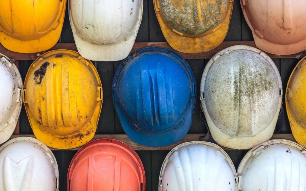 used hard hats sit in rows